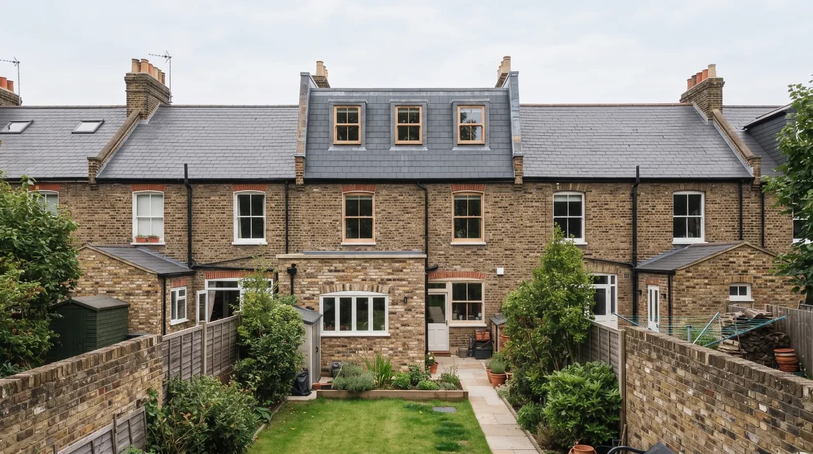 Modern brick terrace with dormer loft conversion, slate roof, and rear garden extension